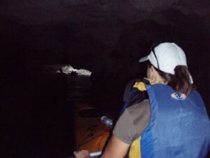 Paddling through a limestone tunnel in Halong Bay 